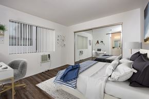 Los Angeles apartment for rent - A bedroom with a bed, chair, and mirror.
