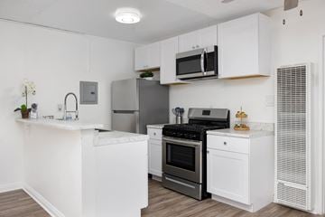 Sherman Oaks apartment for rent - a kitchen with white cabinets and stainless steel appliances