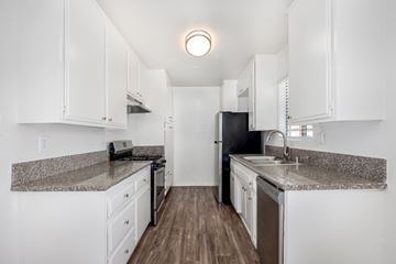 Inglewood apartment for rent - A kitchen with white cabinets and a granite countertop.