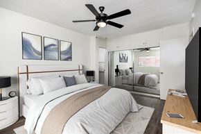Inglewood apartment for rent - A bedroom with a large bed and a ceiling fan.