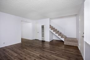 Hawthorne apartment for rent - A room with wooden floors and a staircase.