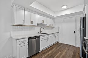 Pasadena apartment for rent - A kitchen with white cabinets and a wooden floor.