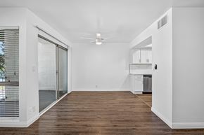 Pasadena apartment for rent - A spacious room with a ceiling fan and a sliding glass door leading to a balcony.