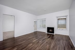 Hawthorne apartment for rent - A room with a fireplace and wood flooring.