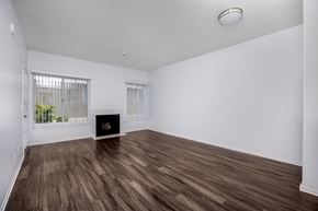Hawthorne apartment for rent - A room with a fireplace and wood flooring.