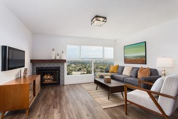 Los Angeles apartment for rent - A living room with a fireplace and a painting on the wall.