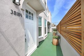 Los Angeles apartment for rent - the entrance to a house with a white door and a wooden fence