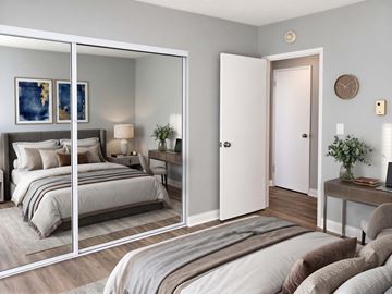 Long Beach apartment for rent - A bedroom with a large bed and a mirrored wardrobe.