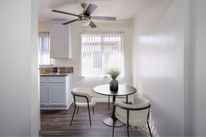 Arcadia apartment for rent - a kitchen and dining area with a table and chairs and a ceiling fan