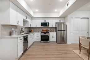 Los Angeles apartment for rent - A modern kitchen with white cabinets and stainless steel appliances.