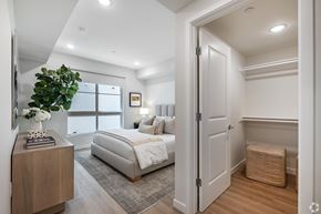 Los Angeles apartment for rent - A bedroom with a large bed and a wooden nightstand.