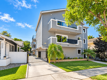 Long Beach apartment for rent - A modern two-story house with a white fence and a tree in front.