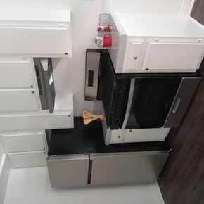 Whittier apartment for rent - A modern kitchen with a black countertop and white cabinets.