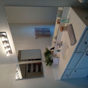 Whittier apartment for rent - A bathroom with a sink, mirror, and lights.
