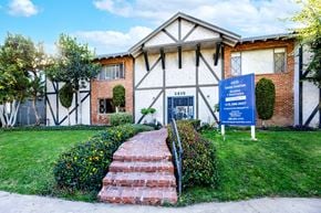 Canoga Park apartment for rent - a building with a blue sign in front of it