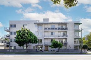 Los Angeles apartment for rent - a white apartment building on the side of a street