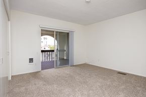 Redondo Beach apartment for rent - an empty living room with an open door to a balcony