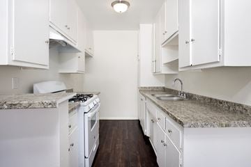 San Gabriel apartment for rent - a kitchen with white appliances and granite counter tops and
