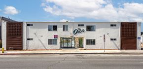 Gardena apartment for rent - a white building with a sign on it on the side of a street