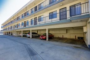 Hawthorne apartment for rent - a parking garage with cars parked in front of a building