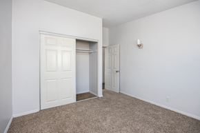 Gardena apartment for rent - a bedroom with white walls and carpet and a closet