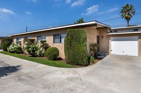 Gardena apartment for rent - a tan brick house with a white garage door