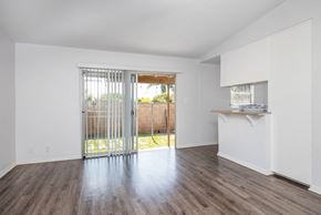 Gardena apartment for rent - an empty living room with a sliding glass door to a backyard