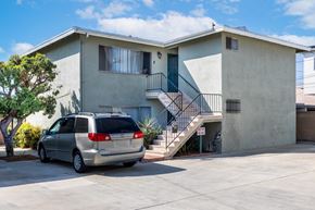 Gardena apartment for rent - a house with a minivan parked in front of it