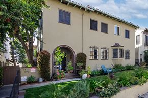 Los Angeles apartment for rent - a house with an arched doorway and a garden outside of it