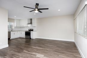 Long Beach apartment for rent - an empty kitchen and living room with a ceiling fan