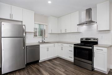 Long Beach apartment for rent - a renovated kitchen with white cabinets and stainless steel appliances