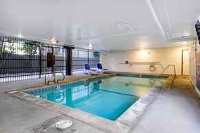 Los Angeles apartment for rent - a swimming pool with chairs and a fence around it