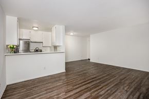 Los Angeles apartment for rent - A kitchen with white cabinets and a wooden floor.