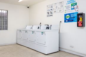 Los Angeles apartment for rent - a laundry room with four washers and a row of washing machines