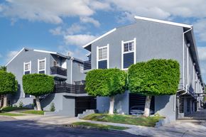 Los Angeles apartment for rent - a blue and white house with three trees in front of it