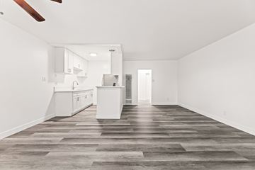 Los Angeles apartment for rent - A spacious kitchen with white cabinets and a wooden floor.