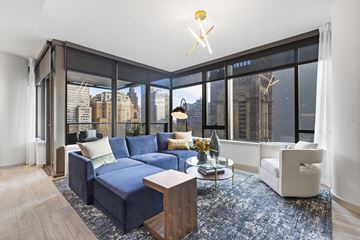 Philadelphia apartment for rent - a living room with a blue couch and a large window