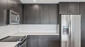 Nashville apartment for rent - A modern kitchen with a stainless steel refrigerator and microwave.
