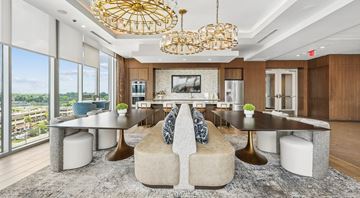 Nashville apartment for rent - A modern living room with a large sectional sofa and a chandelier.