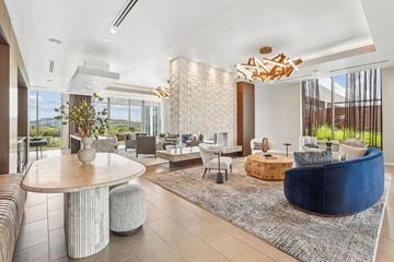 Nashville apartment for rent - A modern living room with a large round table and a blue sofa.