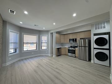Chicago apartment for rent - A spacious kitchen with a washer and dryer built into the cabinetry.