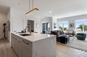 Chicago apartment for rent - A modern kitchen with a marble countertop and a large island.
