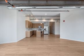 Chicago apartment for rent - A room with wooden floors and white walls.