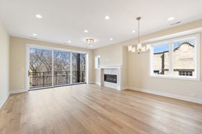 Chicago apartment for rent - an empty living room with a fireplace and a large window