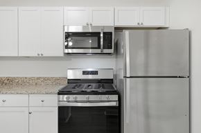 Buffalo Grove apartment for rent - A kitchen with a stove, microwave, and refrigerator.