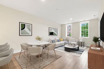 Chicago apartment for rent - A modern living room with a white table and grey chairs.