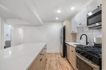 Chicago apartment for rent - A modern kitchen with a white countertop and stainless steel appliances.