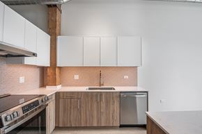 Chicago apartment for rent - A kitchen with a stove top oven and a refrigerator.
