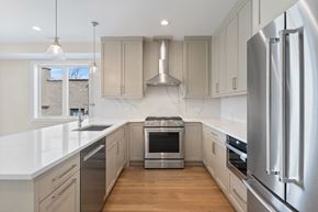 Chicago apartment for rent - a white kitchen with stainless steel appliances and white counter tops