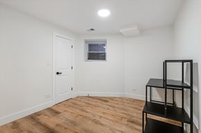 Chicago apartment for rent - A room with a wooden floor and a white door.
